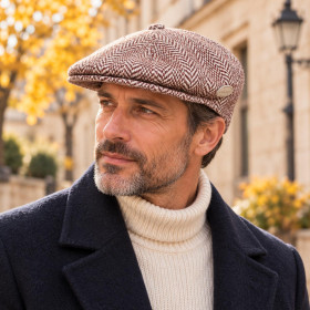 Homme portant une casquette plate Kangol Herringbone 504 marron à chevrons